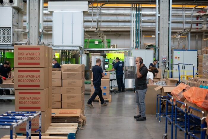 Workers working efficiently in a soundproof warehouse